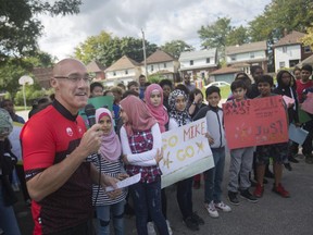 Triathlete Mike Willms is joined by Grade 7 and 8 students from Dougall Public School as he speaks at Bruce Park on Sept. 26, 2018, at the launch of his pledge drive for the Downtown Windsor Community Collaborative. Willms is training to compete in the IRONMAN Florida in November.
