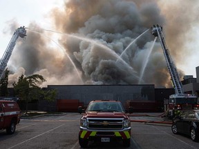 Windsor firefighters deploy aerial platforms to deal with the massive blaze at 1370 Argyle Rd. on Sept. 19, 2018.
