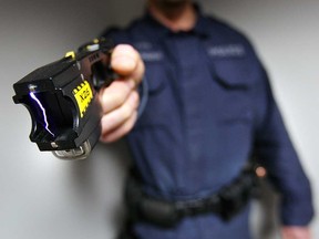 A Windsor police officer demonstrates use of an X26 Taser conducted energey weapon in this 2008 file photo.