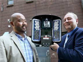 Mike Verzosa, left, of Prime Lighting and Downtown Windsor BIA Chair Larry Horwitz hold a 50-watt LED lighting fixture for Phase 4 of a downtown alley lighting initiative October 3, 2018.  Three phases of the alley lighting have been completed in downtown alleys.  A fourth phase will light up an area around The Capitol Theatre and Phog Lounge.  Each light emits 6,000 lumens.