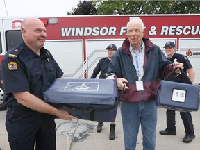 Windsor Fire and Rescue Captain Mike Kennette, left, and Station 7 crew, team up with VON Meals on Wheels volunteer Harold Horneck to make a meal delivery and fire alarm inspection at client's homes in Windsor October 3, 2018.  While the food delivery takes place, firefighters check to make sure their homes haves working smoke detectors.