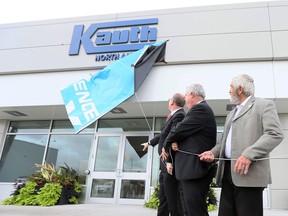 Windsor Mayor Drew Dilkens, left, Steffen May, CFO Kauth North America and Essex County Warden Tom Bain unveil exterior sign of Kauth North America near Windsor Airport October 4, 2018.