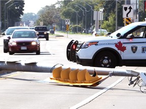 Windsor police block traffic following a two-vehicle collision involving a van which struck a utility pole on Wyandotte Street East at Lauzon Road on Oct. 6, 2018. Eastbound traffic on Wyandotte Street was detoured at Watson Avenue for part of the afternoon.