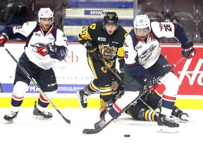 Windsor Spitfires Cole Purboo, right, pounces on a rebound against Hamilton Bulldogs Jake Gravelle.