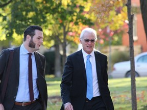 Aylmer Express editor Brett Hueston, left, and his father, John, the publisher, arrive at the Elgin County Courthouse in St. Thomas on Monday. The pair were found not guilty of obstructing a peace officer and trespassing. The OPP laid the charges following a confrontation with the journalists after they arrived at a police scene where a vehicle had driven off a cliff on June 24, 2017, near Port Bruce. DALE CARRUTHERS / THE LONDON FREE PRESS