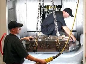 Economy Economy Cavalier Tool and Manufacturing Ltd. workers Jeremy Mateciuk, left, and Tony Copetrone are shown Sept. 26, 2018, mounting a mold cavity onto a Hermle 5-axis CNC high-speed machining centre.
