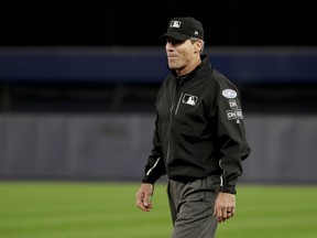 First base umpire Angel Hernandez watches from his position during the second inning of Game 3 of baseball's American League Division Series between the New York Yankees and the Boston Red Sox on Oct. 8, 2018, in New York.