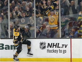 Boston Bruins right wing David Pastrnak (88) reacts after scoring during the first period of an NHL hockey game against the Detroit Red Wings, Oct. 13, 2018, in Boston.