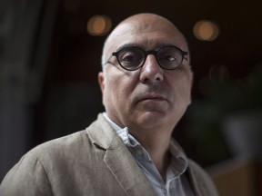Author Rawi Hage poses in Toronto on Aug. 28, 2018, as he promotes his new novel "Beirut Hellfire Society." Acclaimed novelists Hage and Miriam Toews are among the finalists for this year's Governor General's Literary Awards.