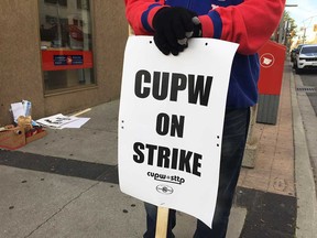 A member of the Canadian Union of Postal Workers on strike in downtown Windsor on Oct. 22, 2018.
