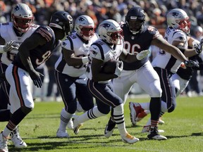 New England Patriots running back Sony Michel (26) runs during the first half of an NFL football game against the Chicago Bears Sunday, Oct. 21, 2018, in Chicago.