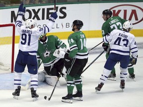 Toronto Maple Leafs center John Tavares (91) celebrates a goal against Dallas Stars goaltender Ben Bishop (30) as left wing Jamie Benn (14) watches in the second period of an NHL hockey game Tuesday, Oct. 9, 2018, in Dallas.