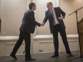 Mayoral candidates Matt Marchand, left, and Mayor Drew Dilkens shake hands before participating in the 2018 Windsor Mayoral Debate presented by the Windsor-Essex Regional Chamber of Commerce at the Fogolar Furlan, Wednesday, Oct. 10, 2018.