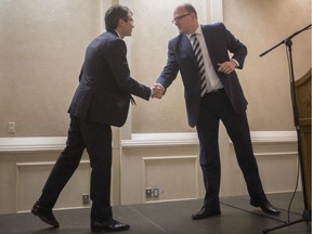 Mayoral candidates Matt Marchand, left, and Mayor Drew Dilkens shake hands before participating in the 2018 Windsor Mayoral Debate presented by the Windsor-Essex Regional Chamber of Commerce at the Fogolar Furlan on Oct. 10, 2018.