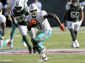 FILE - In this Sept. 16, 2018, file photo, Miami Dolphins running back Frank Gore (21) runs against the New York Jets during an NFL football game, in East Rutherford, N.J. Frank Gore's latest 100-yard rushing game was the 46th of his career, and even at age 35, he has no intention of stopping there.