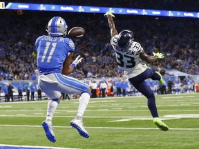 Seattle Seahawks defensive back Tedric Thompson (33) stretches but is unable to deflect a 39-yard pass for a touchdown to Detroit Lions wide receiver Marvin Jones (11) during the first half of an NFL football game, Sunday, Oct. 28, 2018, in Detroit.