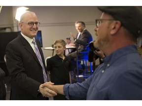 Mayor Drew Dilkens and Ward 4 Coun. Chris Holt congratulate each other at the St. Clair College Centre for the Arts, Monday, Oct. 22, 2018.
