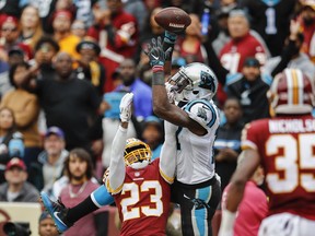 Carolina Panthers wide receiver Devin Funchess (17) pulls in a touchdown pass under pressure from Washington Redskins cornerback Quinton Dunbar (23) during the first half of an NFL football game, Sunday, Oct. 14, 2018, in Landover, Md.