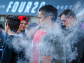 People lined up at FOUR20 Premium Market in Calgary on Friday after recreational cannabis was legalized. Across the country, early reports suggest the roll-out has not gone as smoothly as hoped.
