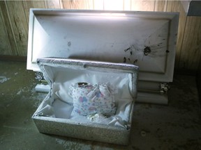 A small casket at the former Cantrell Funeral Home is seen Monday, Oct. 15, 2018 in Detroit. The casket contained a baby and was one of the 11 badly decomposed infant remains that were found by Michigan inspectors on Friday, Oct. 12, hidden in a ceiling compartment of the shuttered Detroit funeral home.