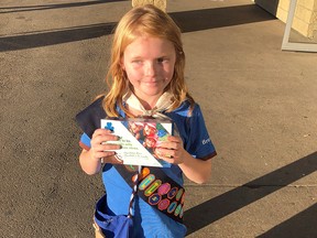 Elina Childs poses as she sells Girl Guide Cookies outside a cannabis store in Edmonton on Wednesday, Oct. 17, 2018 in this handout photo. (THE CANADIAN PRESS/HO - Seann Childs)