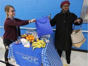 The Windsor Essex Community Health Centre hosted a free community health fair on Thursday, Oct. 25, 2018, at their new location in the  Sandwich Community Health Centre. The event which featured a flu shot clinic, exercise demos, nutrition advice and addiction counselling was part of Community Health and Wellbeing Week. Alexandra Wiseman, left, a health promoter gives Florence Germain some fresh fruit.