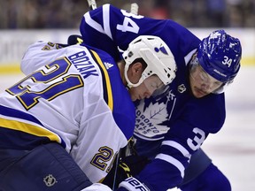 St. Louis Blues centre Tyler Bozak (21) and Toronto Maple Leafs centre Auston Matthews (34) battle for the puck at faceoff during third period NHL action in Toronto on Oct. 20, 2018.