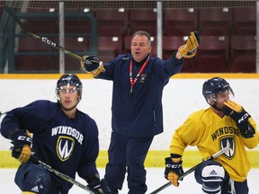 Windsor Lancers men's hockey head coach Kevin Hamlin makes a point to his players during practice at South Windsor Arena.