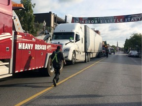 Welcome to Windsor's Little Italy. A tractor trailer gets a heavy-rescue lift after having trouble making it through the traffic roundabout at Erie Street East and Parent Avenue on Oct. 4, 2018.