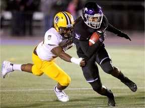 Cedric Joseph of the Mustangs runs out of the grasp of Windsor's Courtney Ellis during their night game at TD Stadium in London Thursday. (Mike Hensen/The London Free Press)
