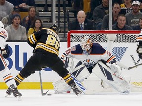 Boston Bruins right wing David Pastrnak (88) scores a goal against Edmonton Oilers goaltender Cam Talbot (33) during the first period of an NHL hockey game Thursday, Oct. 11, 2018, in Boston.