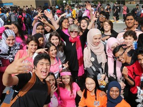 Joan Rankin, centre wearing a pink scarf, principal of Vincent Massey Secondary School is surrounded by a group of Grade 9 students on Thursday, October 4, 2018, at the Windsor school. Massey has a significant increase in grade 9 students this year.