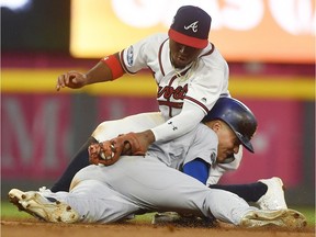 Los Angeles Dodgers' Enrique Hernandez steals second base against Atlanta Braves second baseman Ozzie Albies during the seventh inning in Game 4 of baseball's National League Division Series on Oct. 8, 2018, in Atlanta.