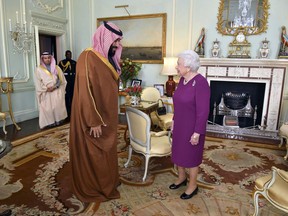 FILE - In this Wednesday March 7, 2018 file photo, Queen Elizabeth II greets Saudi Arabian Crown Prince of Saudi Arabia Mohammed bin Salman, during a private audience at Buckingham Palace in London.