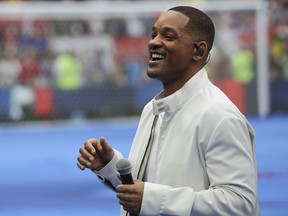 FILE - In this July 15, 2018, file photo, singer and actor Will Smith performs during the closing ceremony prior to the final match between France and Croatia at the 2018 soccer World Cup in the Luzhniki Stadium in Moscow, Russia. The star on Wednesday, Oct. 10, revealed the first poster of Disney's remake of "Aladdin." Smith, who plays the Genie, wrote on Facebook: "LEMME OUT! Can't wait for y'all to see Me BLUE."