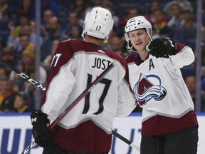 Colorado Avalanche forwards Tyson Jost (17) and Nathan MacKinnon (29) celebrate a goal during the first period of the team's NHL hockey game against the Buffalo Sabres, Thursday, Oct. 11, 2018, in Buffalo, N.Y.
