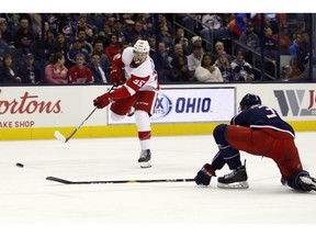 Detroit Red Wings forward Anthony Mantha, left, shoots the puck against Columbus Blue Jackets defenseman Seth Jones for a goal during an NHL hockey game in Columbus, Ohio, Tuesday, Oct. 30, 2018.