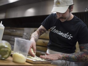 Dean Litster of Armando's Pizza in Windsor prepares his signature creation - Windsor-style deep dish - on Oct. 16, 2018. The unique pizza won Litster the title of Chef of the Year (open category) at the Canadian Pizza Summit on Oct. 15.