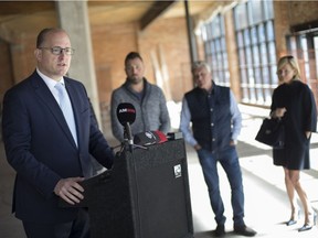 Mayor Drew Dilkens, left, is joined by Anthony and Dino Maggio, owners of Mid South Land Development Corp., and Lisa Schwab, wife of Cypher Systems co-owner, Brian Schwab, at a press conference announcing that Quicken Loans will be occupying the former Loop complex on Monday, Oct. 15, 2018.