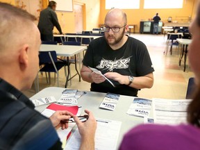 Salvation Army resident James Bloomfield, 37, talks to City of Windsor staff about registering to vote in the upcoming municipal election. Photo taken Oct. 15, 2018.