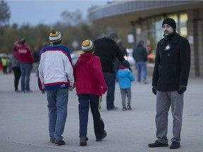 An enforcement agent monitors to see that people aren't smoking on WFCU Centre grounds before the Windsor Spitfires game, Thursday, October 25,  2018.