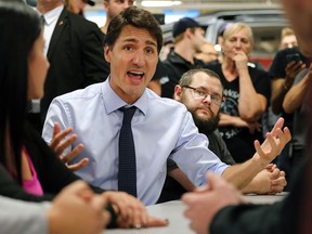 Prime Minister Justin Trudeau chats with Fiat Chrysler Windsor Assembly Plant workers during his tour of the facility on Friday, Oct.5, 2018.