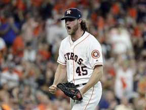 Houston Astros starting pitcher Gerrit Cole (45) reacts after striking out Cleveland Indians' Jose Ramirez to end the sixth inning of Game 2 of a baseball American League Division Series, Saturday, Oct. 6, 2018, in Houston.