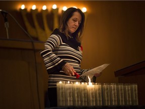 Karen Rosen, Congregation Beth El president, lights candles to honour those killed in a synagogue in Pittsburgh while at an interfaith memorial service at Temple Beth El, Tuesday, Oct. 30, 2018.