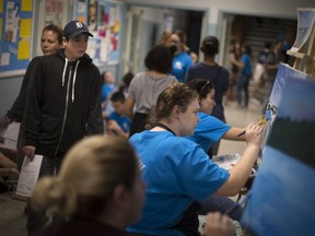 Students paint for guests during the Walkerville Centre for the Creative Arts Open House, Wednesday, October 10, 2018.