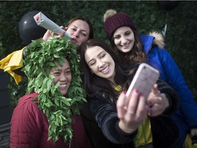 Aphria employees, from left, Jennifer Anderson, Meagan Battersby, Jacqueline Jacobs, and Tiffany Aziz, pose for a group selfie at the Aphria Inc. BBQ celebrating the legalization of cannabis in the Jose's Bar and Grill parking lot in Leamington on Wednesday, Oct. 17, 2018.