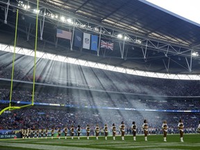 Cheerleaders line up before an NFL football game between Tennessee Titans and Los Angeles Chargers at Wembley stadium in London, Sunday, Oct. 21, 2018.