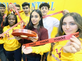 Catholic Central students Laran Aref, left, Masika Nzondero, Mariam Ramadan and Rivadin Kazo, right, hold red ribbon with their classmates during the launch of MADD Windsor and Essex County Project Red Ribbon Campaign Thursday.
