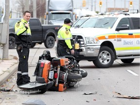 Windsor-Essex EMS paramedics maintain the scene on Walker Road at St. Julien Avenue following a collision involving a Harley Davidson motorcycle and a Nissan SUV November 2, 2018.