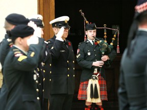 Piper Cpl. Nathan Duczman, centre, The Essex and Kent Scottish Pipes and Drums performs Lament during Rotary Club of Windsor (1918) Remembrance Day Commemorative Service at Giovanni Caboto Club of Windsor on Nov. 5, 2018.
